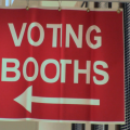 A sign for voting booths